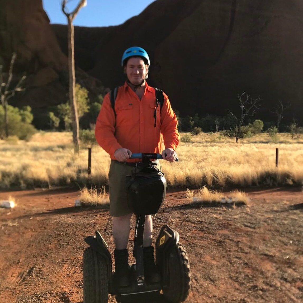 Uluru Tour Guide Chris Chris rides a Segway at Uluru